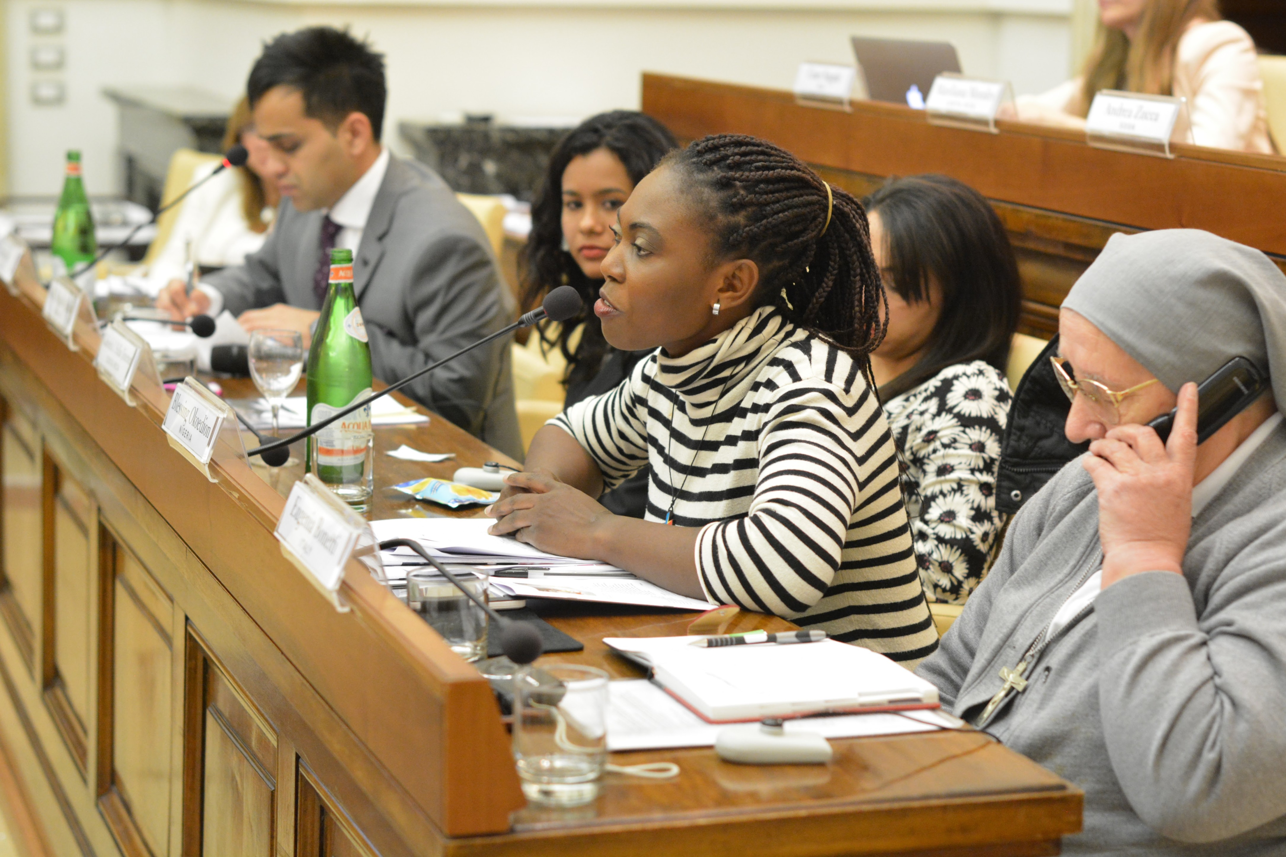 Woman addressing a room as a panel member.