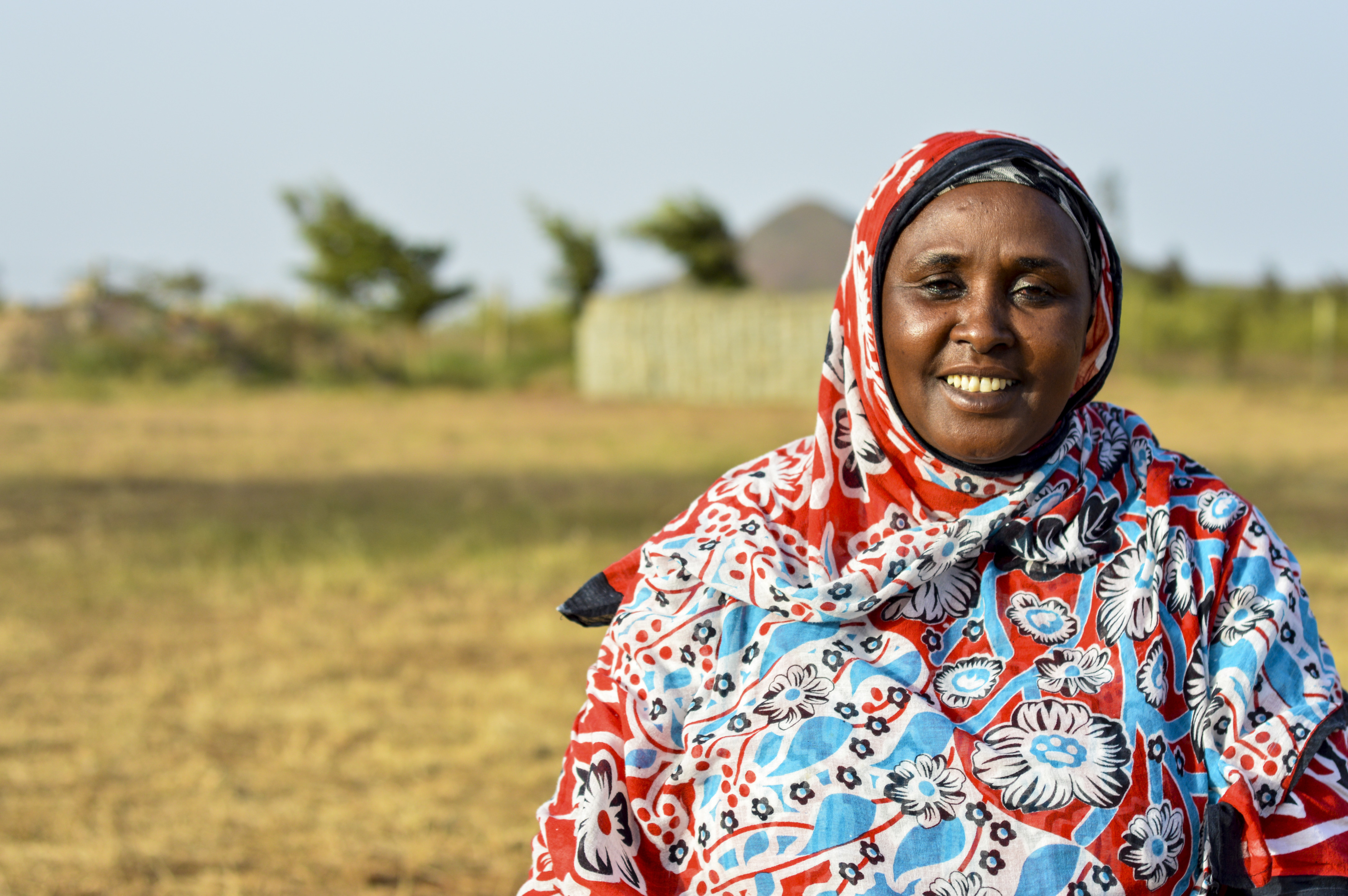 Batula Hassan standing in front a field